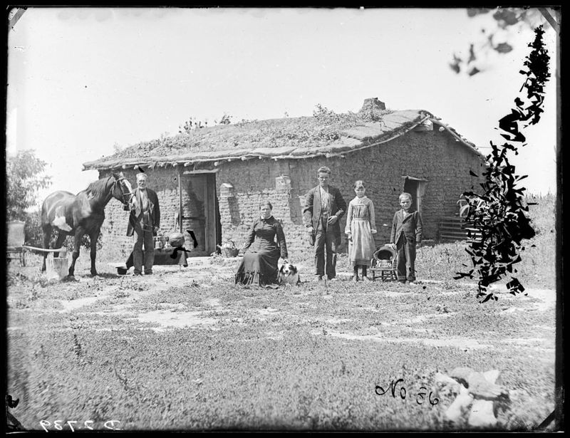 Prairie Family Posing With Their Sod House